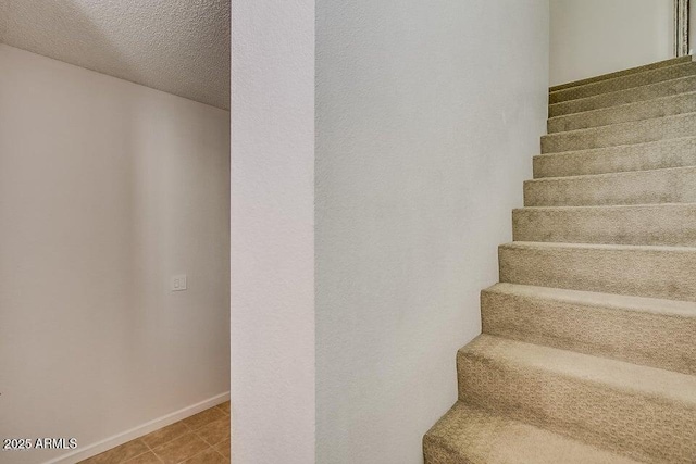 stairway with a textured ceiling