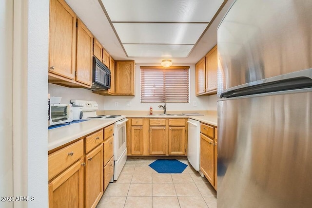 kitchen featuring light tile patterned flooring, sink, and white appliances