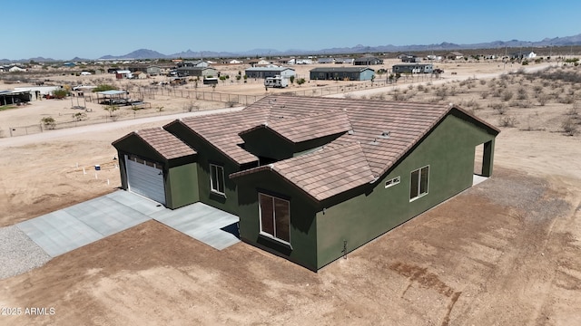 37478 W Hayes St, Tonopah, AZ 85354 - view of front of house featuring concrete driveway, a mountain view, and stucco siding