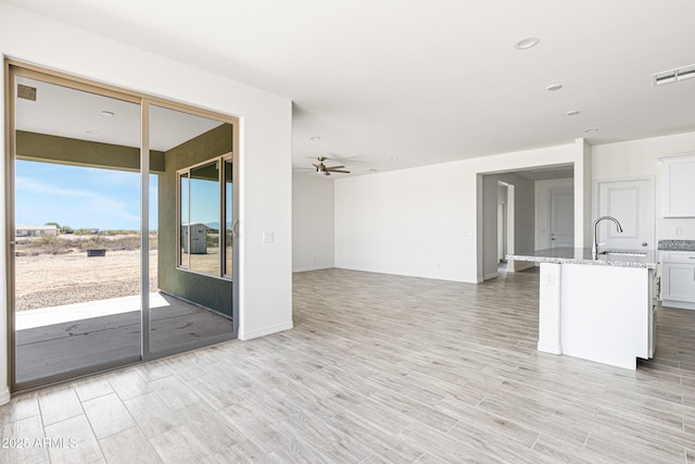 37478 W Hayes St, Tonopah, AZ 85354 - unfurnished living room featuring light wood-type flooring, ceiling fan, and recessed lighting