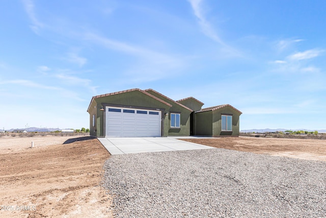 37478 W Hayes St, Tonopah, AZ 85354 - ranch-style house with driveway, a garage, a mountain view, a tiled roof, and stucco siding