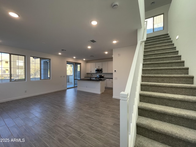 stairs with sink and wood-type flooring