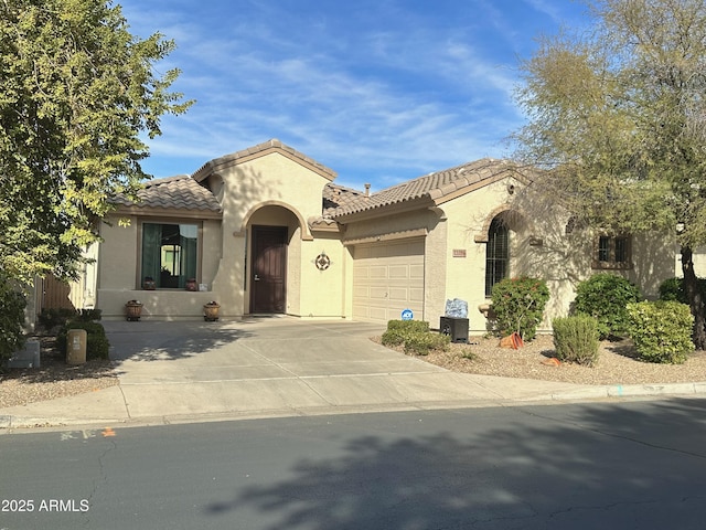 mediterranean / spanish home with a garage