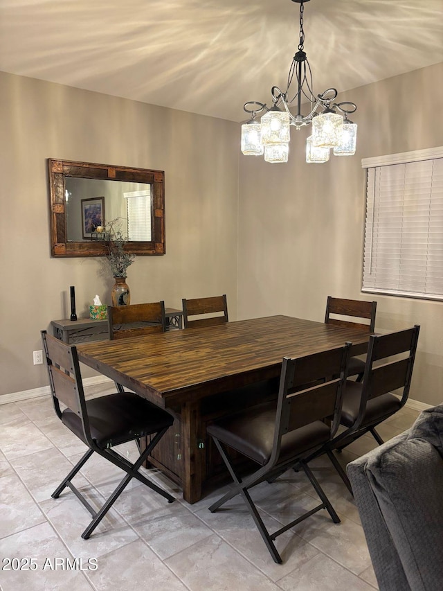 dining area featuring light tile patterned floors and baseboards