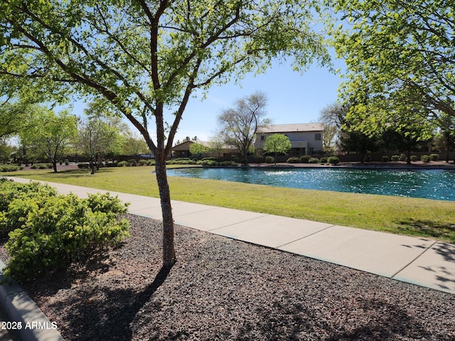 outdoor pool featuring a yard