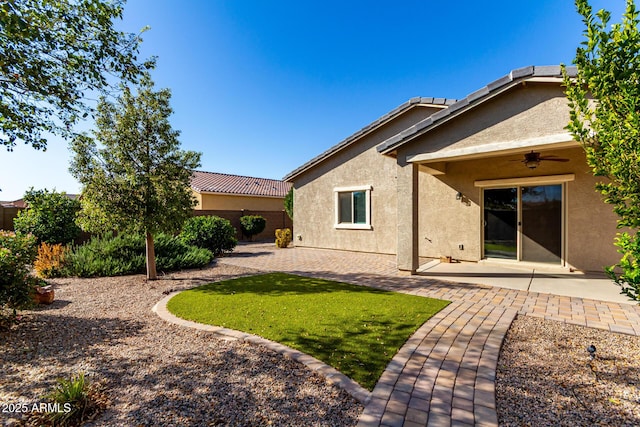 back of house featuring stucco siding, a patio, and a ceiling fan