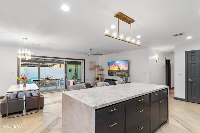 kitchen with recessed lighting, open floor plan, and a center island