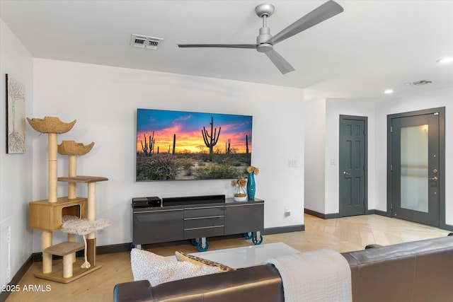 living room featuring a ceiling fan, recessed lighting, visible vents, and baseboards