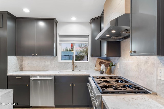 kitchen with tasteful backsplash, wall chimney exhaust hood, stainless steel appliances, a sink, and recessed lighting