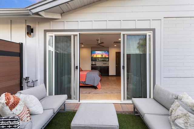 entrance to property featuring visible vents and an outdoor hangout area