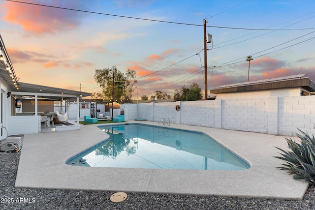 pool at dusk with a fenced in pool, a patio area, and a fenced backyard