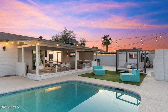 rear view of house with a patio area, central AC, outdoor lounge area, and a fenced in pool