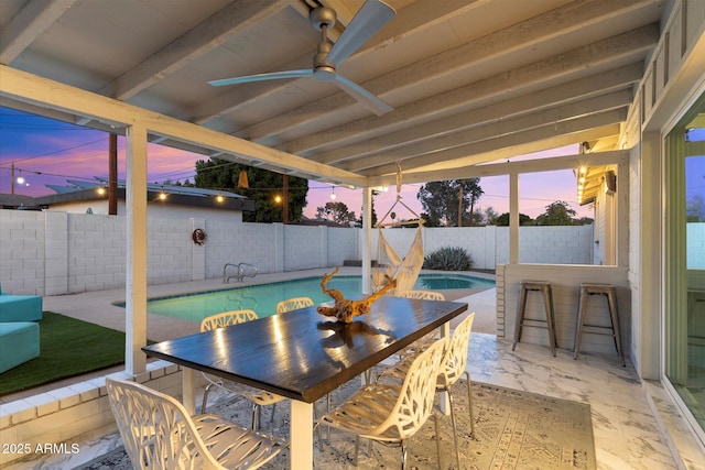 view of patio featuring ceiling fan, outdoor dining space, a fenced backyard, and a fenced in pool