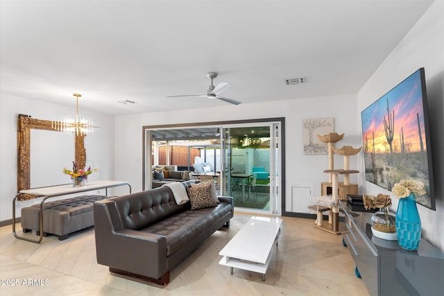 living area featuring ceiling fan with notable chandelier and visible vents