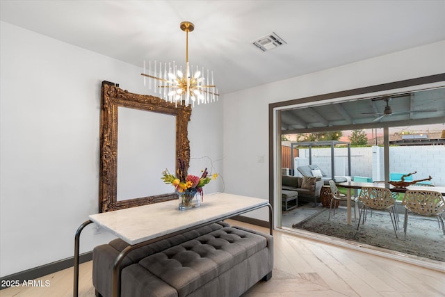 dining room with baseboards, visible vents, and a notable chandelier