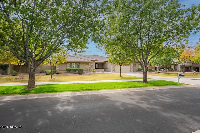 view of front of property with a garage and a front lawn