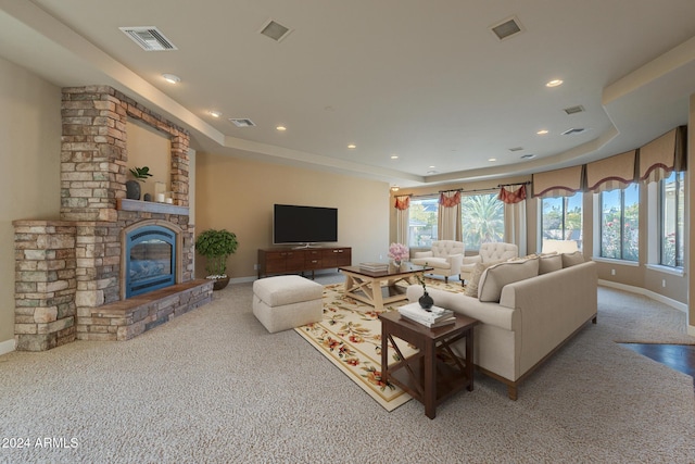 living room featuring a fireplace and light carpet