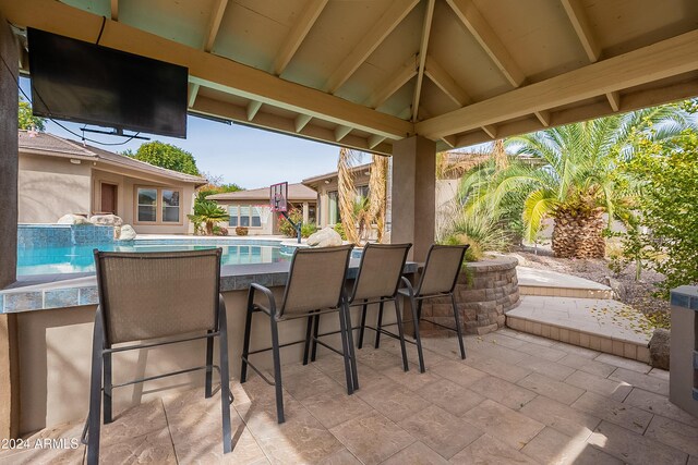 view of patio with an outdoor bar