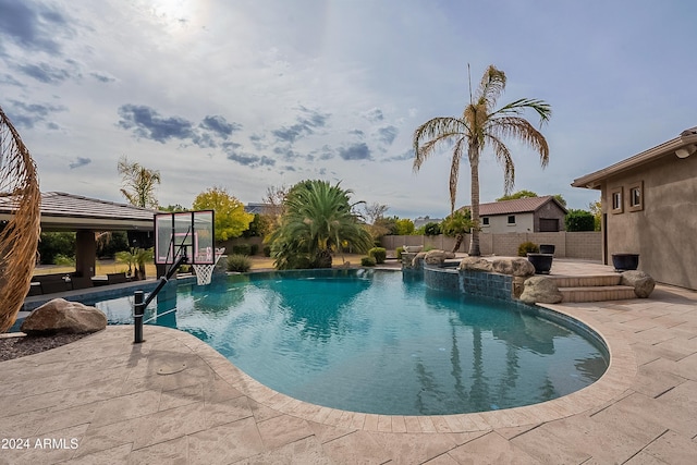 view of swimming pool with a patio and pool water feature