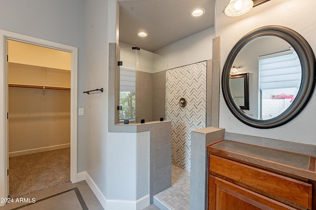 bathroom featuring tile patterned floors and a tile shower