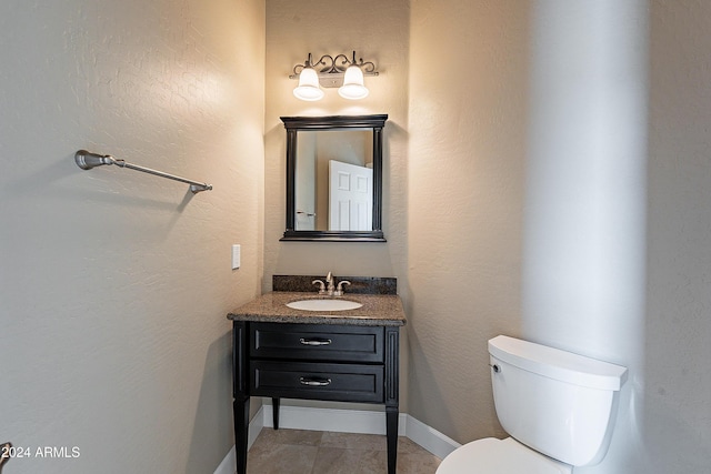 bathroom featuring tile patterned floors, vanity, and toilet