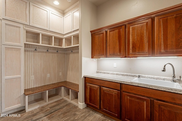 mudroom with light hardwood / wood-style flooring and sink