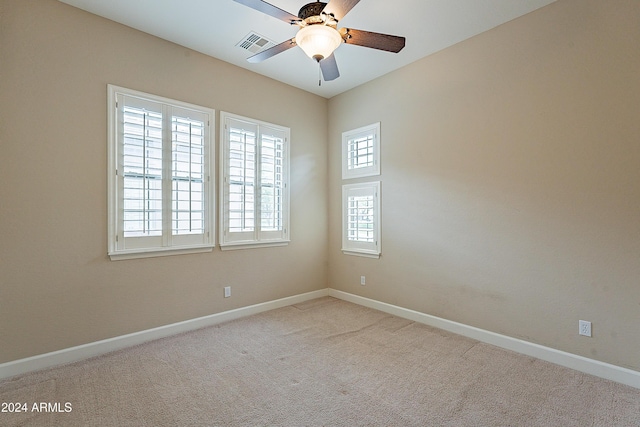 empty room featuring ceiling fan and light colored carpet