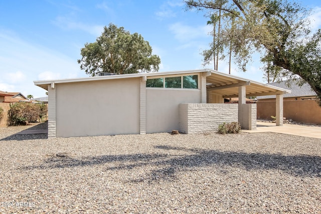 view of side of home with a carport