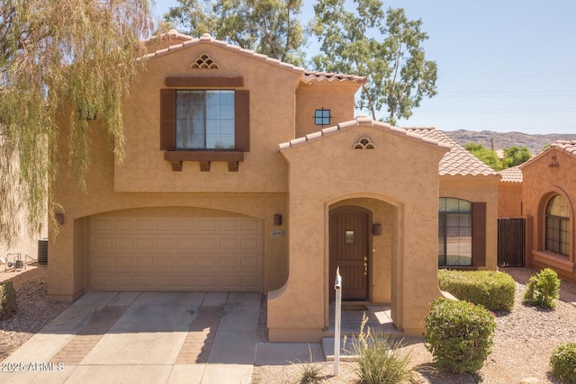 3041 E Fremont Rd, Phoenix, AZ 85042 - mediterranean / spanish house featuring stucco siding, a tiled roof, and concrete driveway
