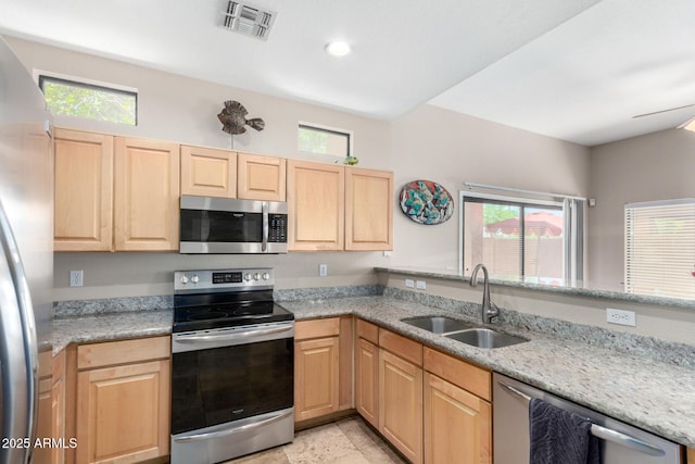 3041 E Fremont Rd, Phoenix, AZ 85042 - kitchen featuring appliances with stainless steel finishes, light brown cabinets, healthy amount of natural light, light stone counters, and recessed lighting