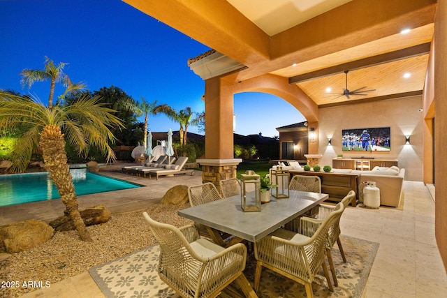 view of patio with an outdoor pool, outdoor dining area, and a ceiling fan