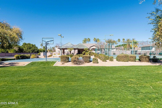 exterior space with community basketball court and fence