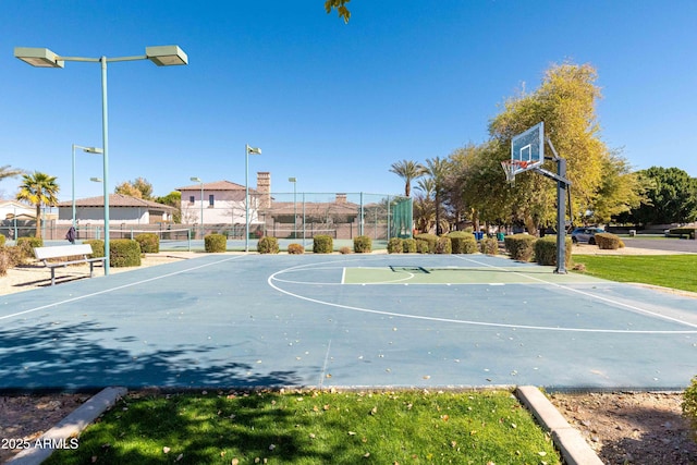 view of basketball court featuring community basketball court and fence