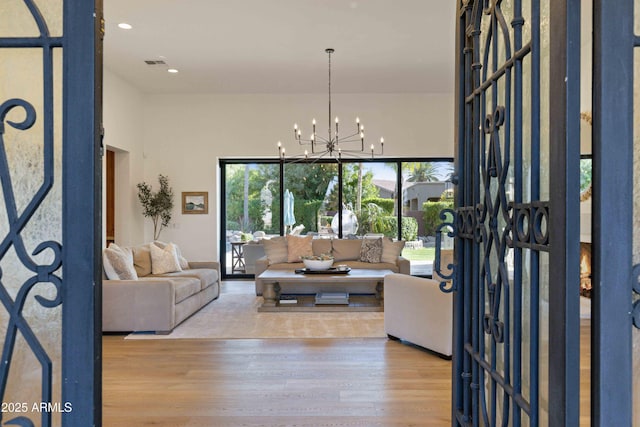 living room with visible vents, a chandelier, wood finished floors, and recessed lighting