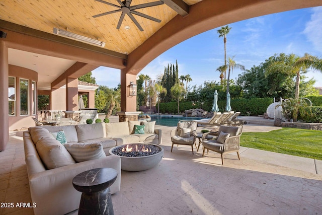 view of patio with ceiling fan, an outdoor pool, and an outdoor living space with a fire pit