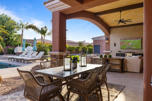 view of patio featuring a ceiling fan, outdoor dining area, and an outdoor pool