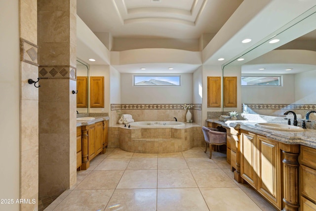 bathroom with tile patterned flooring, two vanities, a sink, and a bath