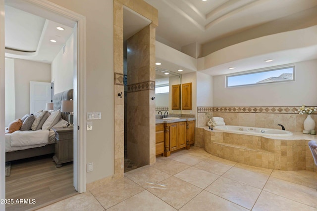 full bathroom with tile patterned floors, vanity, a bath, and ensuite bathroom