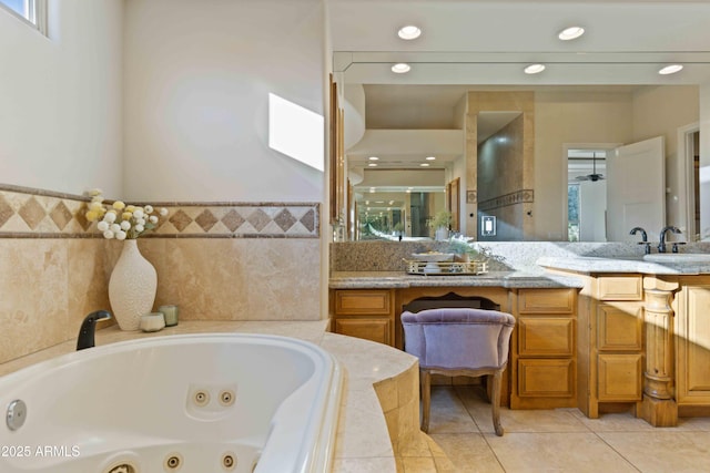 full bath with a jetted tub, recessed lighting, vanity, and tile patterned floors