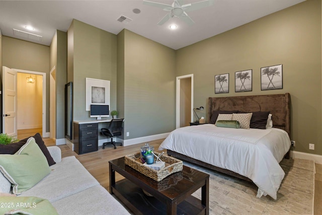 bedroom featuring visible vents, ceiling fan, light wood-style flooring, and baseboards