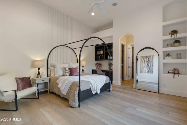 bedroom featuring recessed lighting, a ceiling fan, a towering ceiling, baseboards, and light wood-type flooring