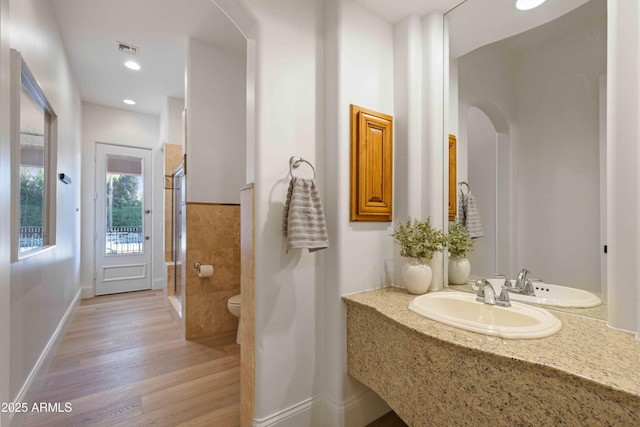 full bath featuring visible vents, toilet, wood finished floors, a shower stall, and a sink