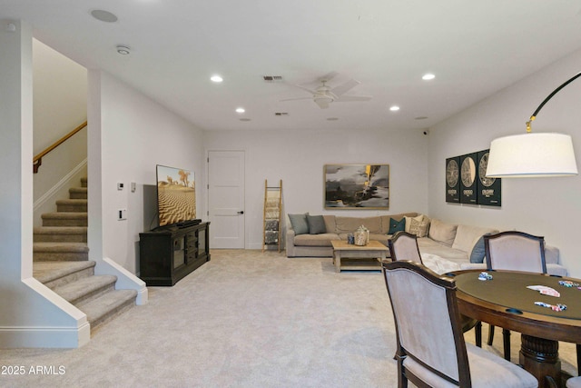 living area with recessed lighting, light carpet, visible vents, and stairs