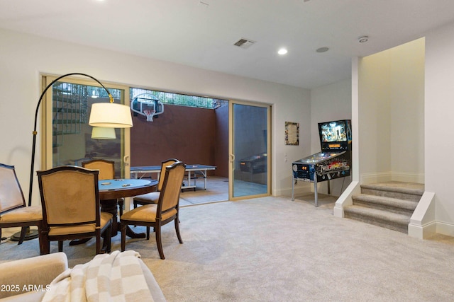 dining room featuring recessed lighting, light carpet, visible vents, baseboards, and stairs