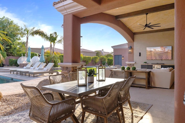 view of patio with ceiling fan, outdoor dining area, and an outdoor pool