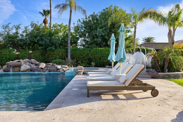 view of pool featuring an in ground hot tub, a patio area, and a fenced in pool