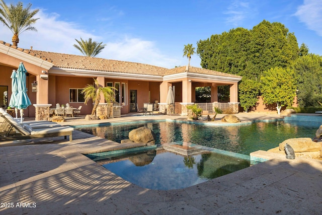 view of pool with a pool with connected hot tub and a patio