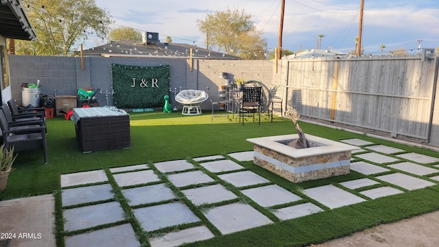 view of yard with a patio and a fire pit