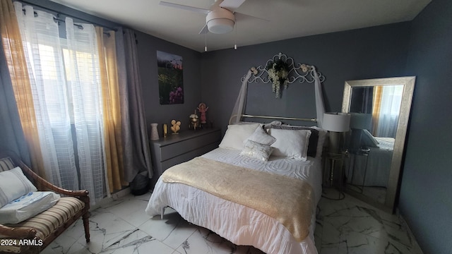 tiled bedroom featuring ceiling fan