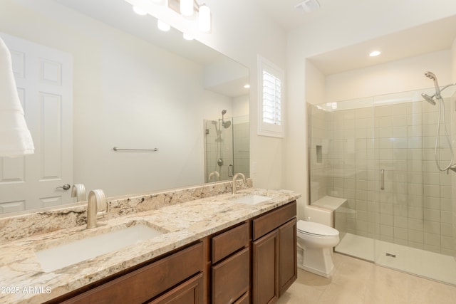 bathroom featuring tile patterned floors, vanity, toilet, and an enclosed shower